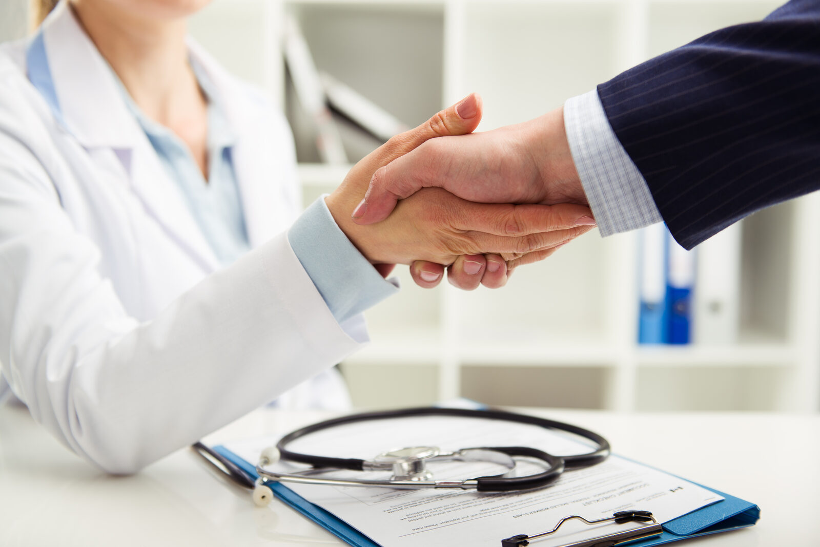 A licensed agent shaking hands with a client